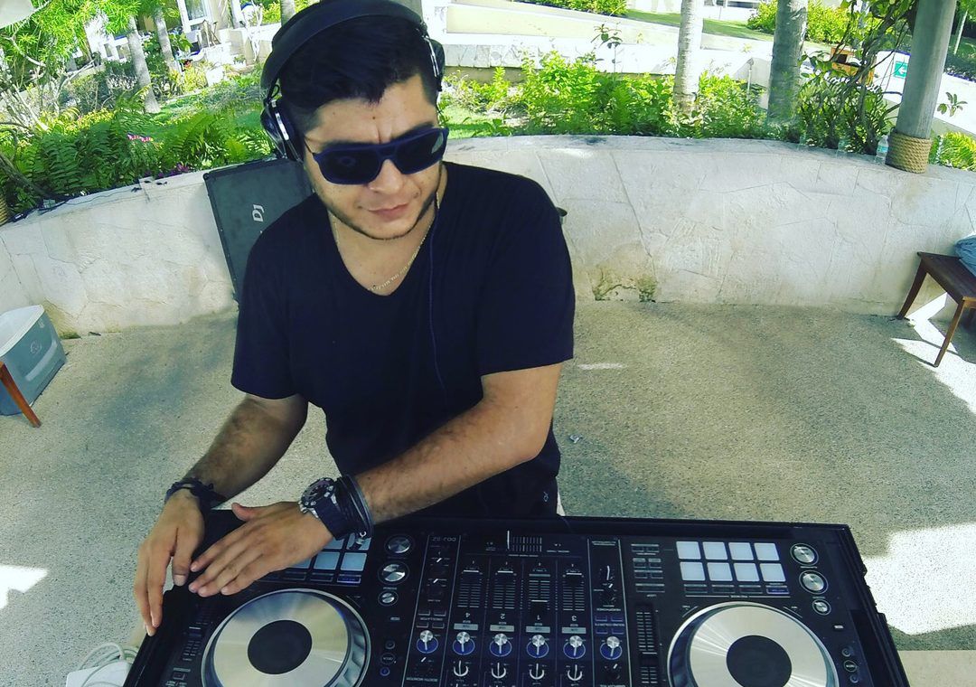 Mau Lemus at the controller under the palms