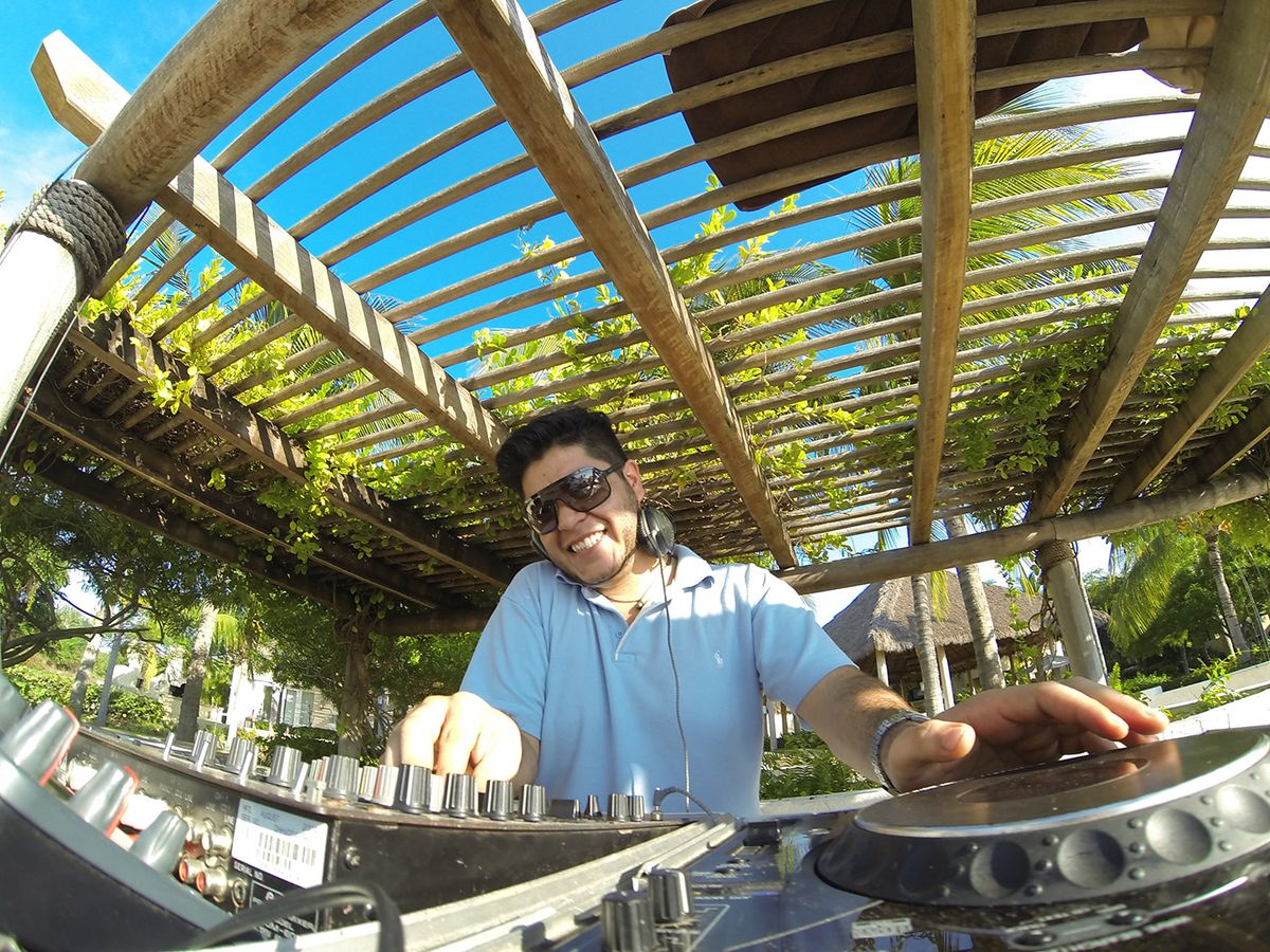 Mau Lemus playing under a beach club pergola